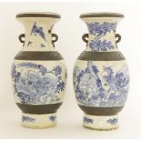 A pair of Chinese blue and white vases, c.1900, painted with a phoenix amongst peony, the reverse