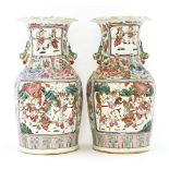 A pair of Chinese famille rose vases,late 19th century, each painted with panels of figures in a