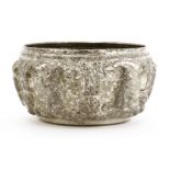 A Thai silver bowl,19th century, decorated in relief with dancing figures between columns, under