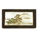 A Japanese ceramic plaque, late 19th century, painted with trees by a river under moonlight,