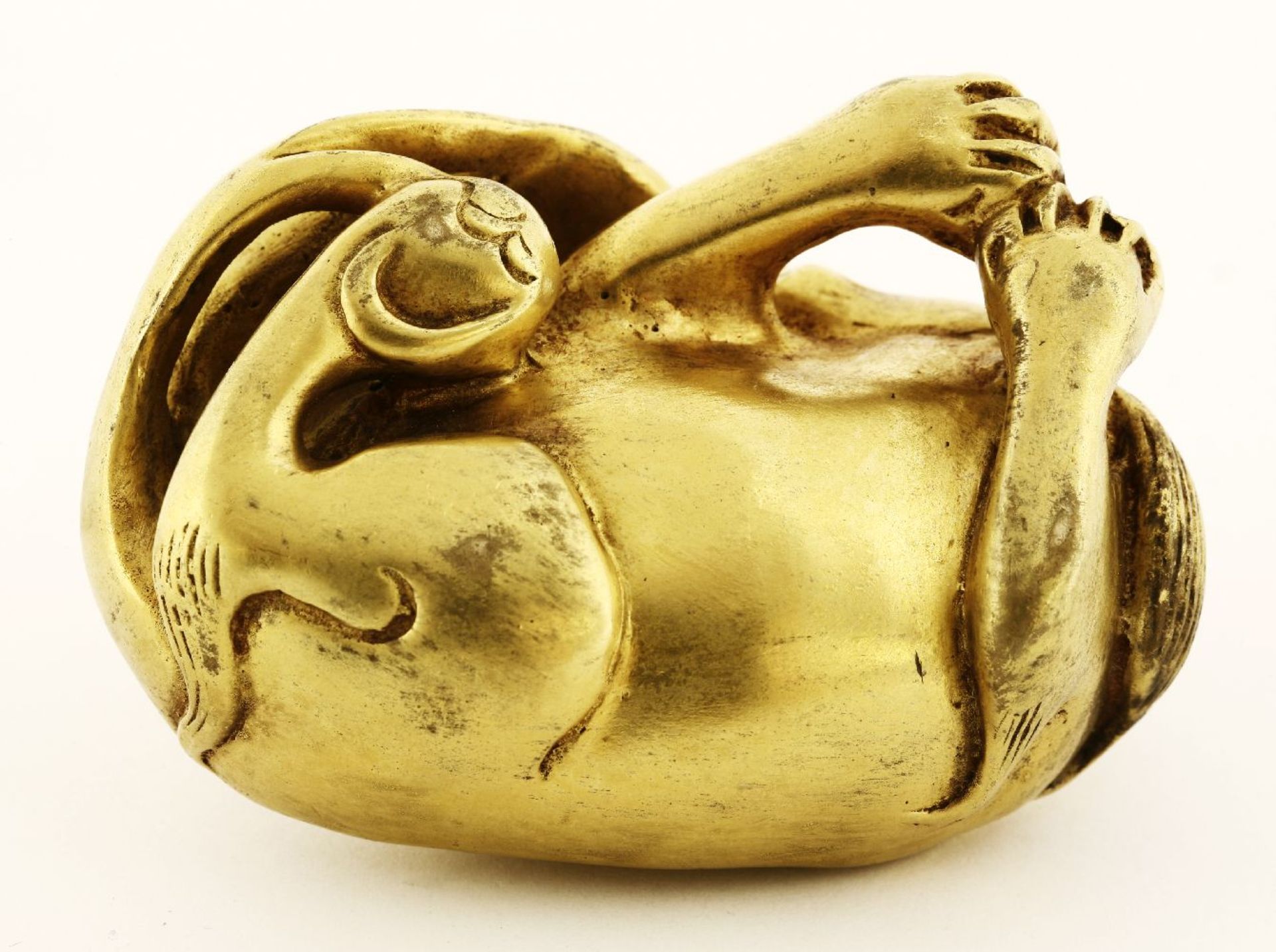 A gilt bronze paper weight, of a recumbent mythical beast, its head tilted to reach its tail, 6.5cm - Image 3 of 3