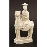 A Chinese blanc de Chine group,18th century, of a European man riding horseback with a hat and a