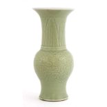 A Chinese celadon vase,Kangxi (1662-1722), of baluster shape with a flared mouth, incised with