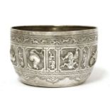 A Thai silver bowl,19th century, of circular form on a flat base, decorated with mythical beasts