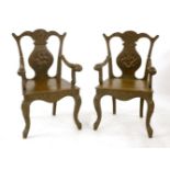 A pair of Chinese armchairs, 20th century, carved with dragons within a border of shou and bats,