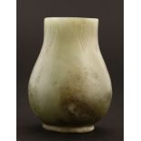 A Chinese yellow jade vase,early 20th century, carved with stylised banana leaves to rim and foot