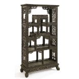 A Chinese blackwood display cabinet,19th century, pierced and carved with scrolling lotus, on a