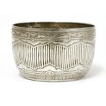 A Thai silver bowl,19th century, of circular form on a flat base, decorated with vertical stripes