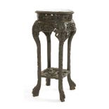 A Chinese vase stand,19th century, the circular top with a false gadroon border, carved in the