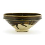 A Chinese Henan kiln black-glazed bowl,Song dynasty, 12th/13th century, of circular form on a