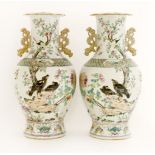 A pair of Chinese famille rose vases,late 19th century, each of baluster form with a lobed, flared