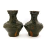 A pair of Chinese lead-glazed vases,possibly Han dynasty (206 BC-AD 220), each bulbous body
