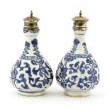 A pair of Chinese blue and white bottles,Kangxi (1662-1722), each of pear shape with a garlic mouth,