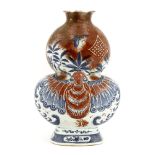 A Chinese blue and white and underglaze copper red vase, 19th century, in the shape of a double