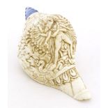 A Chinese white shell, carved with Chakrasamvara and Vajravarahi amongst clouds, blue glass