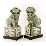 A pair of Chinese famille verte Buddhist lions,possibly Kangxi (1662-1722), one with his left paw on