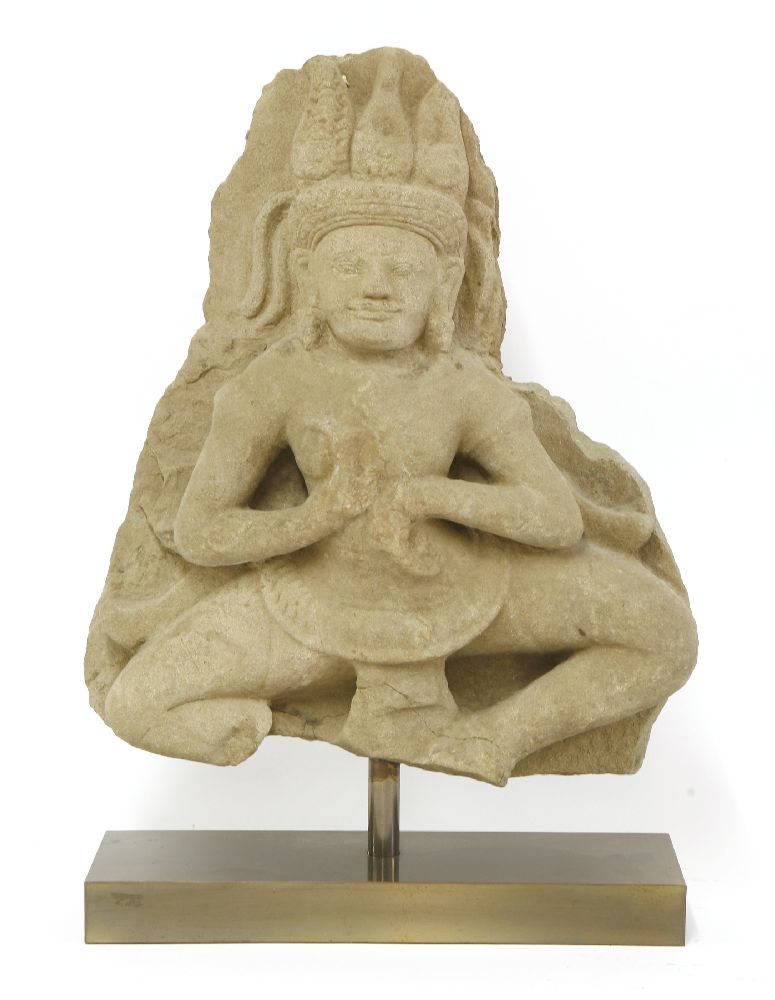 A Khmer sandstone carving of a dancing Apsara,Angkor period, late 12th/early 13th century, in