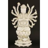 A Chinese blanc de Chine Guanyin, 17th/18th century, seated cross-legged on a lotus throne ascending