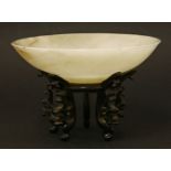 A Chinese jade dish,Qing dynasty (1644-1911), of circular form on a circular base, the stone of pale