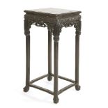 A Chinese vase stand,19th century, the square top inset with rouge marble, above a pierced and