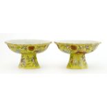 A pair of Chinese famille rose comports,each of lobed form, painted with bats amongst branches of