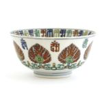 A Chinese doucai bowl,18th/19th century, painted with scrolling fruiting pomegranates under a border