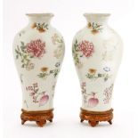 A pair of Chinese famille rose wall pockets, each painted with sprigs of flowers including peony,