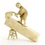 A Japanese ivory okimono,Meiji period (1868-1912), of a carpenter standing on a section of log