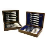 Two silver and mother of pearl six place fish and fruit sets, in oak cases