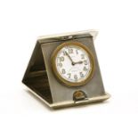 A silver and engine turned 'Pop Up' travel clock,1936, Birmingham, the white dial with luminous