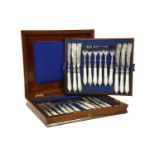 A cased set of twelve pairs of Victorian silver dessert knives and forks, Birmingham 1877, in a