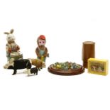 A collection of toys including a clockwork rabbit, a monkey with drill, and two animal fur miniature
