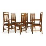 A set of six Arts and Crafts oak dining chairs, each with tapering backs with vertical splats and