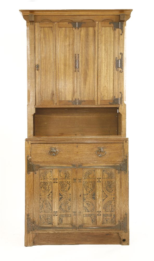 A Continental Arts & Crafts oak bookcase, with an hinged and panelled folding upper section with