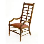 An Aesthetic walnut armchair,with a ladder back and an embroidered drop-in seat
