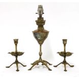 A pair of W A S Benson silver-plated candlesticks,with petal drip pans, on tripod stands, each