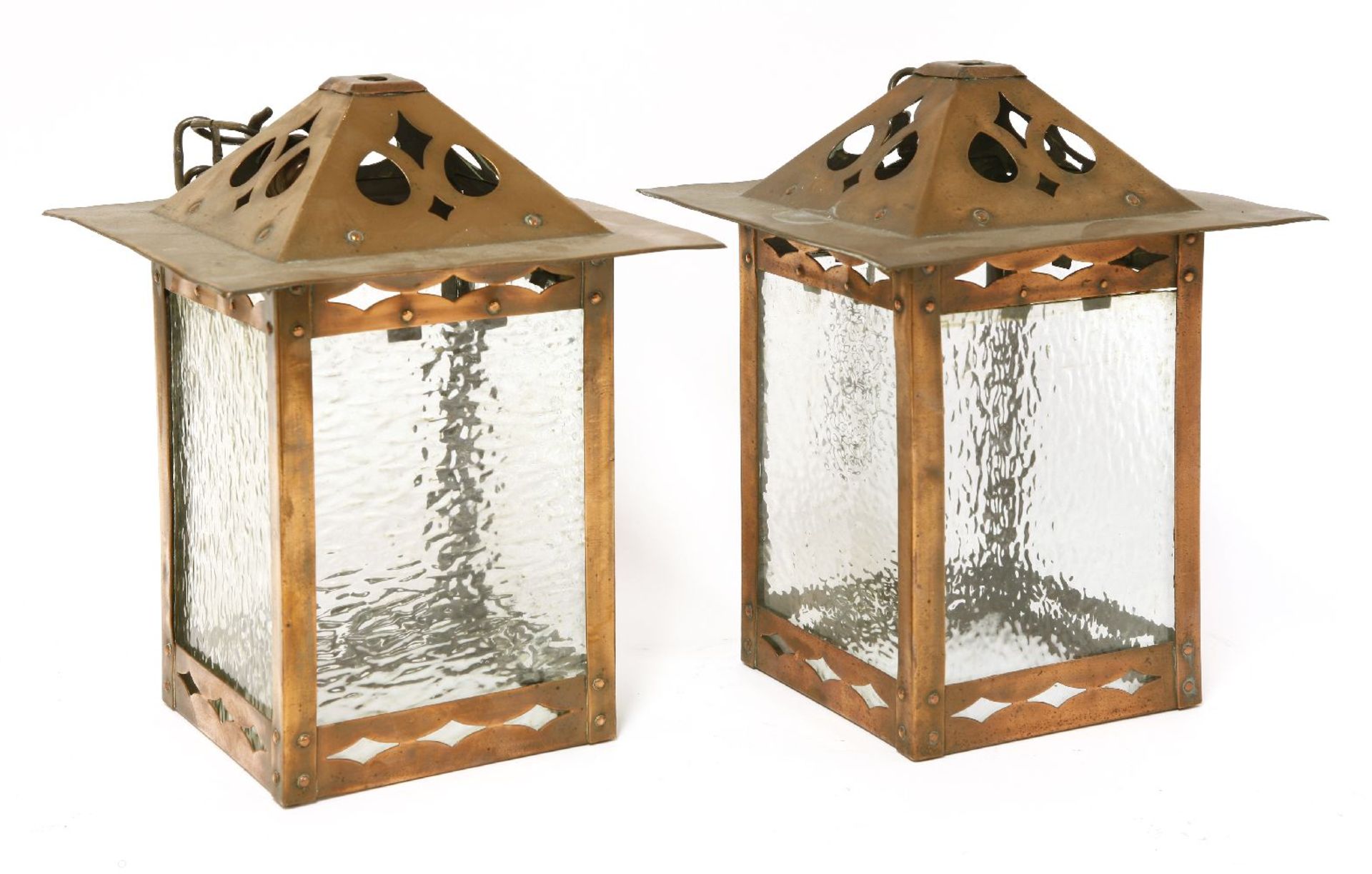 A pair of copper hall lanterns,with pierced details, mounted with mottled glass panels, one