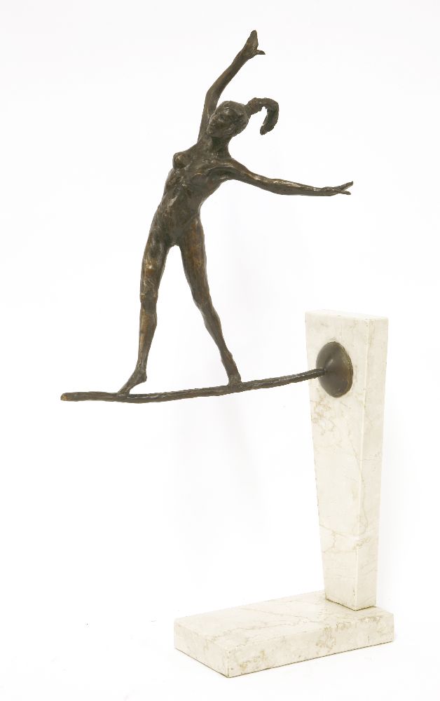 A contemporary bronze and marble sculpture,modelled as a girl balancing on a tight rope, mounted