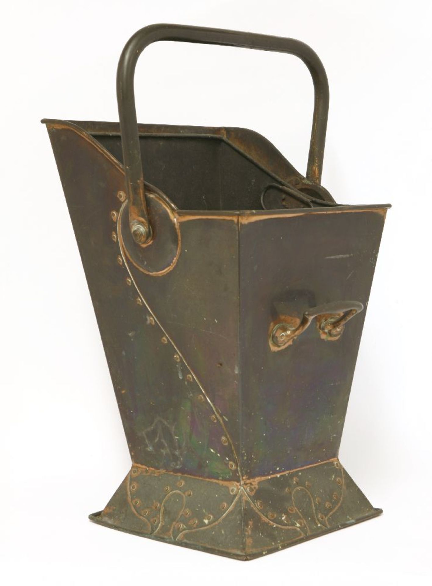 A copper coal scuttle, with riveted panels and embossed with a stylised pomegranate, with a swing