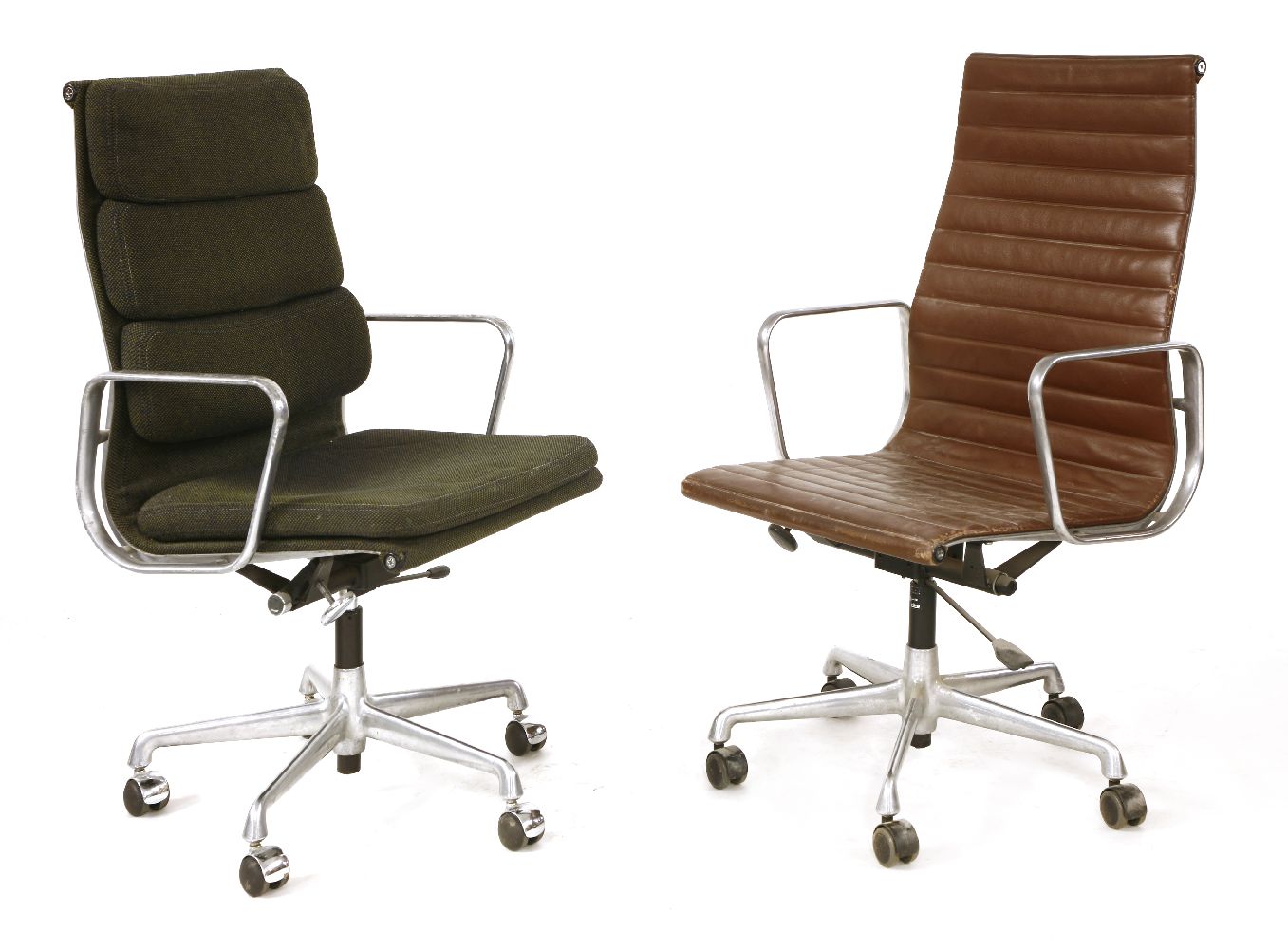 A desk chair, designed by Charles Eames, a Vitra edition with a brown leather seat, andanother,
