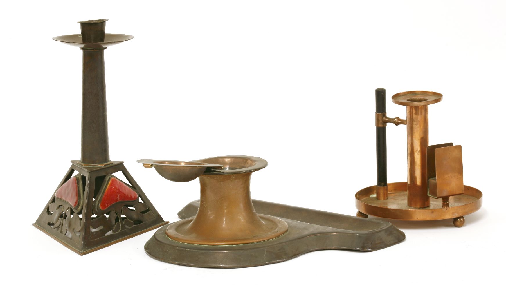 An Arts and Crafts copper desk stand,by Rathbone, with an hinged inkwell, lacking a glass liner, and