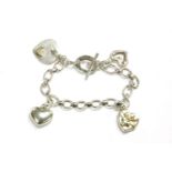 A Links of London silver oval link chain bracelet, with four assorted heart shaped charms, marked