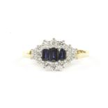 An 18ct gold sapphire and diamond cluster ring, three graduating baguette cut sapphires to a cluster