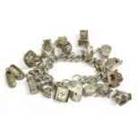 A silver charm bracelet with padlock, and a quantity of assorted silver charms including a