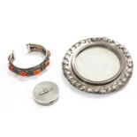 A silver cuff bangle set with Cornelian cabochons, between floral plaques, flanked by twisted rope