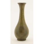 A Chinese bronze vase, 18th century or later, of pear shape with long neck and flared mouth, on