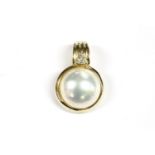 A gold coloured mabé pearl and diamond set three stone cluster ring, marked 14k, 5853.30g