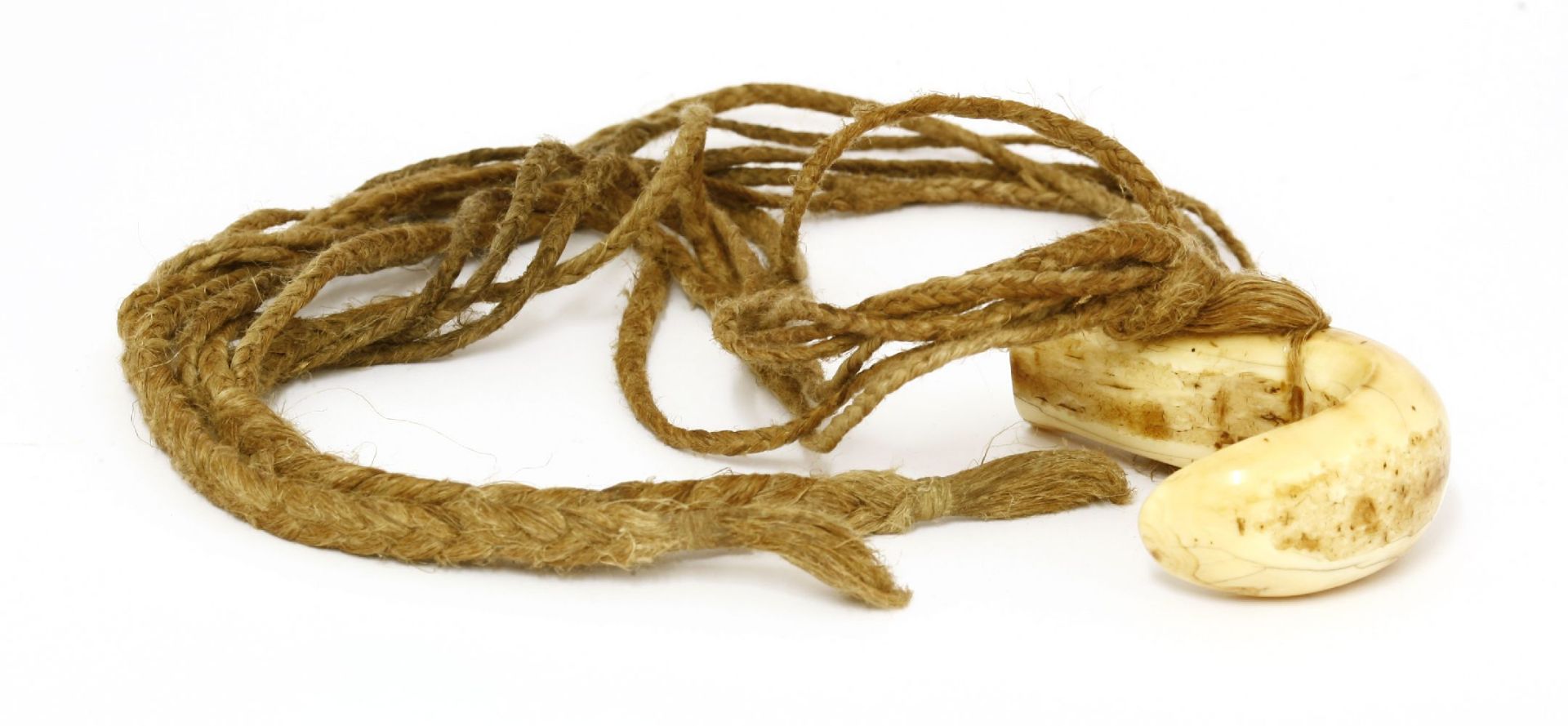 A whale tooth necklace,19th century, possibly a 'Lei niho palaoa', Pacific Islands, with a woven