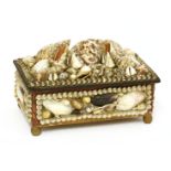A shell-mounted 'sailor's valentine' dressing table box,19th century, the hinged top mounted with