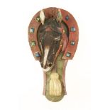 A carved pine and painted farrier's shop sign,late 19th century, in the form of a horse's head